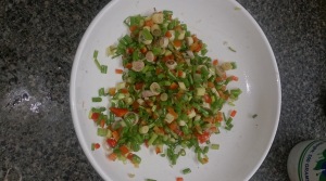 a mixture of spring onion, red bell peppers, lemon grass, salt and pepper